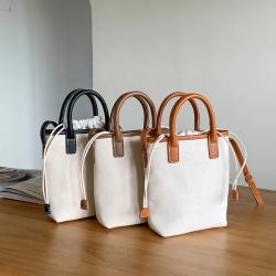 Factory wholesale PU fabric hand bag drawstring design tote bag women weaving design diagonal bucket bag ladies