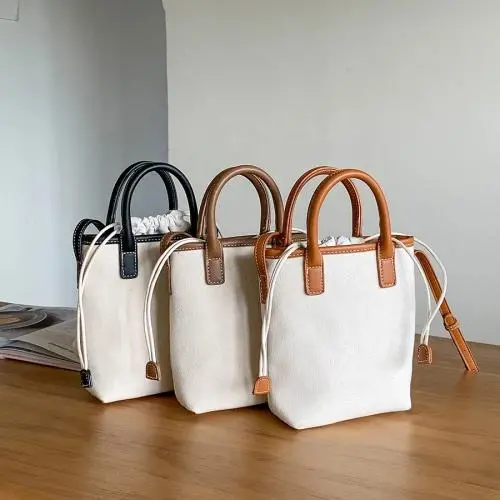 Factory wholesale PU fabric hand bag drawstring design tote bag women weaving design diagonal bucket bag ladies